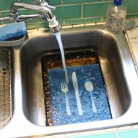 Overhead view of the print being rinsed with water in the sink