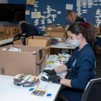 Bellco employee putting art kits together