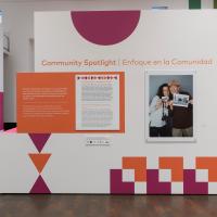 The introductory text and installation of the Community Spotlight photo exhibition