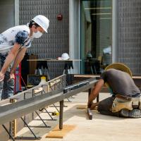 Two men working on constructing the Sensory Garden