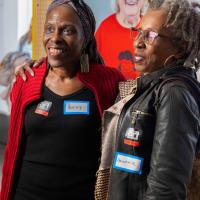 Two women smiling and posing inside the exhibition