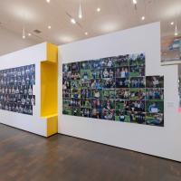 Installation view of a wall of photographs
