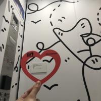 Hand holding a paper heart inside Shantell Martin's "Elevator" at the Denver Art Museum.