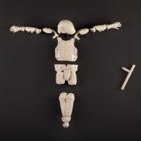 'God Complex,' by Nicholas Galanin which features a white porcelain police suit in a crucified pose. 