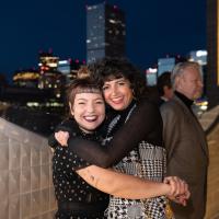 Two women hugging and posing for the camera on the museum's roof.