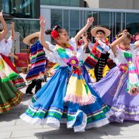 Group of children performing while dressed in traditional clothing