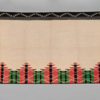 An Acoma Pueblo textile with graphic designs embroidered on the top and bottom