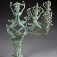 Three figures atop a chariot ornament