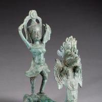 Bronze sculpture of a figure riding a snake-like chariot