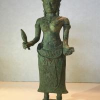 Bronze sculpture of a female figure holding a torch