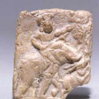 Terracotta stone plaque featuring a figure from West Bengal