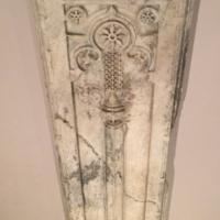 Vertical marble slab with circles and patterns carved in