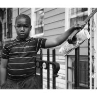 Young black boy posing near a stoop