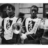 Two young Black girls in their marching band school uniforms