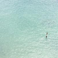 Woman maroooned in the light blue ocean waters