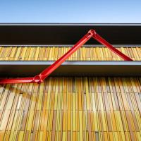 Outdoor red abstract sculpture adorning the Kirkland Museum building