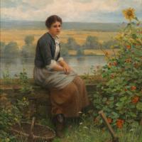 A woman sitting on a log by the lake, contemplating
