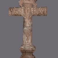 Small sculpture of a cross made out of volcanic stone