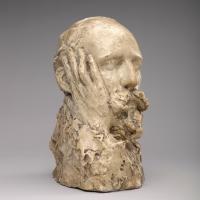 Bust of a man with a hand touching the side of his face