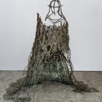 Abstract bronze installation resembling a maiden wearing a large flowing gown