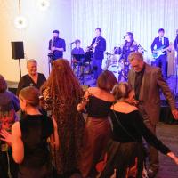 Group of adults dancing at a black-tie event