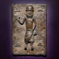 Plaque of a helmeted figure in a warrior pose