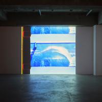 Video installation in empty warehouse-like gallery space