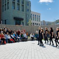 Young dancers performing before a large crowd outside at Dia del Nino