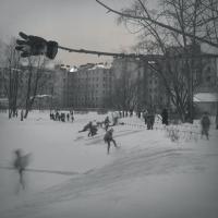 Kids skating on a snowy ice rink