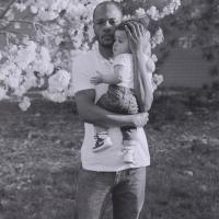 Black man holding his young infant child close