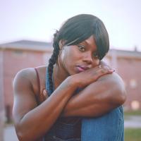Candid portrait of an African American woman folding her arms