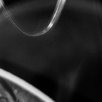 Extreme close-up of a man wearing a t-shirt with a snippet of a face visibile