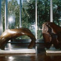 Two bronze statues resembling a large, oversize bull horn and bull skull