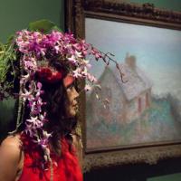 A model with a floral headdress from the Adornment performance by Arthur Williams