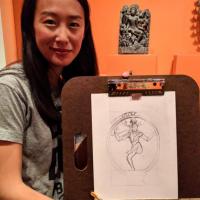 a woman holding a drawing of Shiva she drew in the Linking Asia exhibition