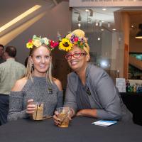 two women with cocktails and flower crowns at Untitled Final Friday