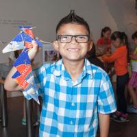 Child with his completed art project during a school field trip at the Denver Art Museum.