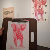 drawing of a poster with a red elephant on it in the Stampede exhibition