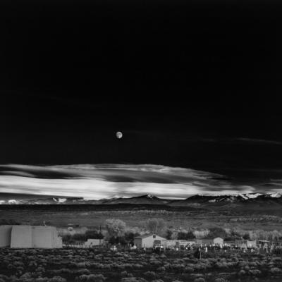 Black and white photo of a moonlit landscape.