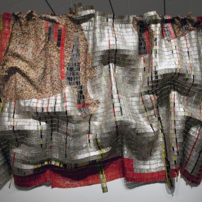 Metal is threaded together to create the appearance of fabric, mainly silver, red and yellow colors