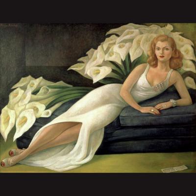 Natasha Gelman lying on a sofa in a long white gown reminiscent of the large white calla lillies behind her