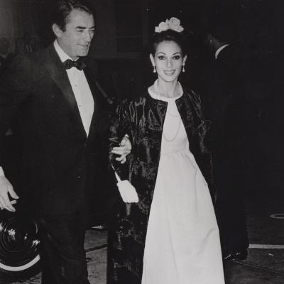 Gregory Peck escorting his wife Veronique to a film premiere, both dressed in formal black-and-white clothing
