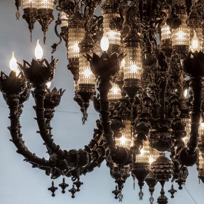 close up of black chandelier hanging in the gallery