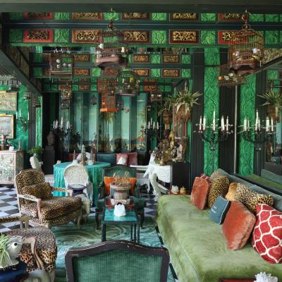 View of heavily decorated and designed green living room