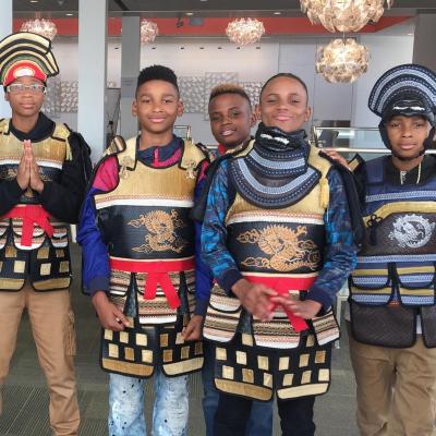 Four kids posing in makeshift Samurai suit and armor