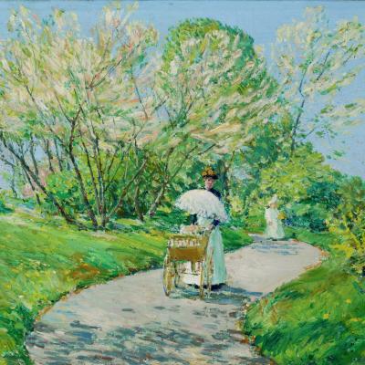 Woman pushing baby buggy and holding parasol walking down winding path between trees and grassy areas