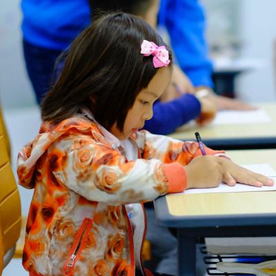 Young girl writing at a desk