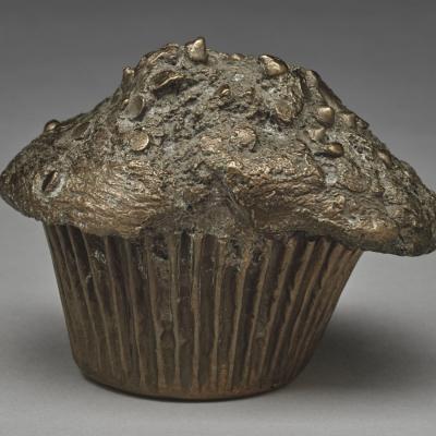 Bronze sculpture of a chocolate chip muffin by artist Jude Tallichet.