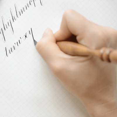 Woman writing calligraphy on stationary