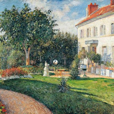 Woman in the lush green garden outside a large white estate